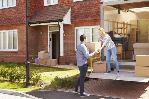 Careful loading of household furniture into a removal vehicle in Ealing