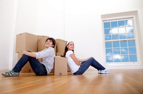 Man with van loading household furniture in Ealing