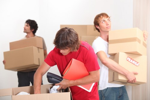 Moving items down a narrow staircase in an Ealing apartment building