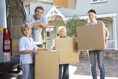 Professional movers loading household items at an Ealing property