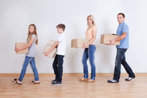 Unpacking boxes and arranging rooms after a move in Ealing