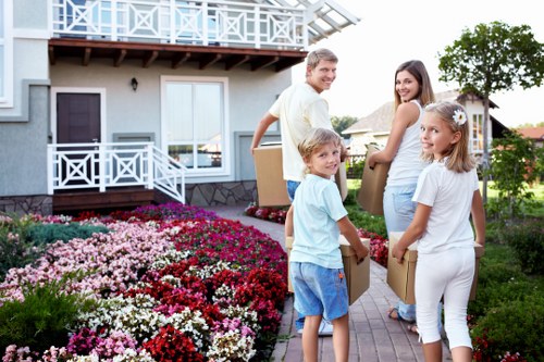 Professional movers carrying items safely with protective equipment